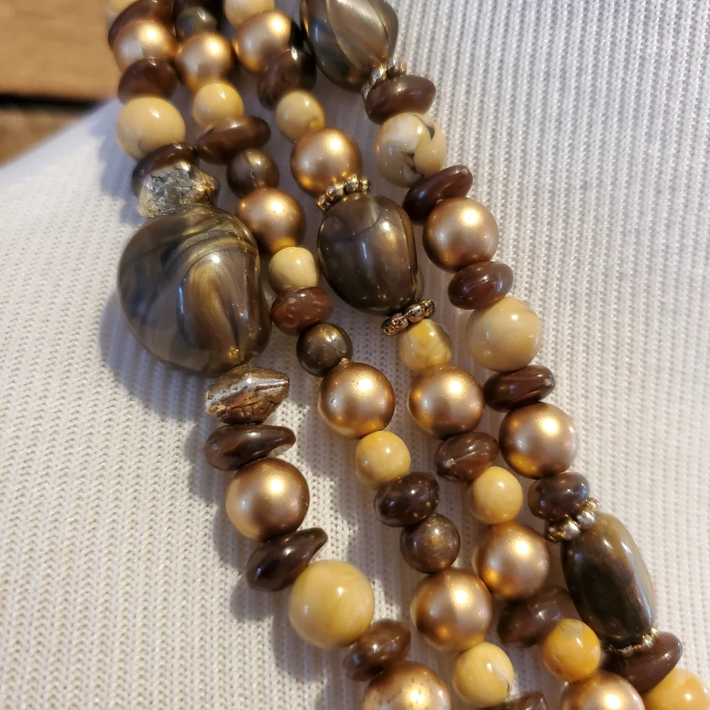 Multi-strand necklace in gold, brown, cream and faux tiger eye beads
